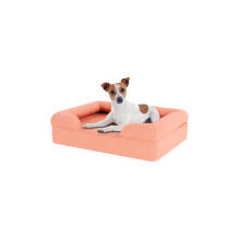 Hund sitter på liten persika rosa memory foam bolster hund säng