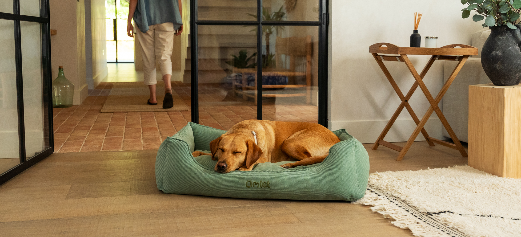 Labrador peacefully sleeping on their Omlet Nest dog bed in Corduroy Moss